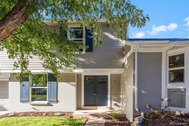 view of exterior entry with covered porch