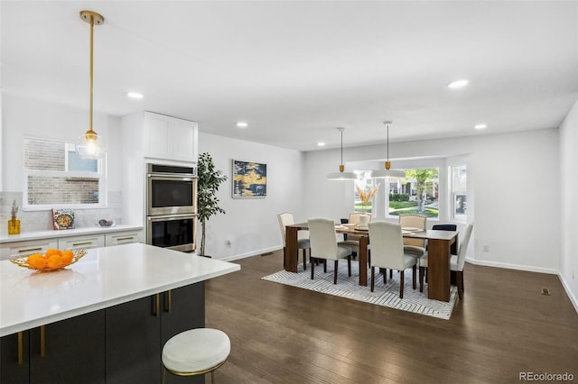 dining area featuring dark wood-type flooring