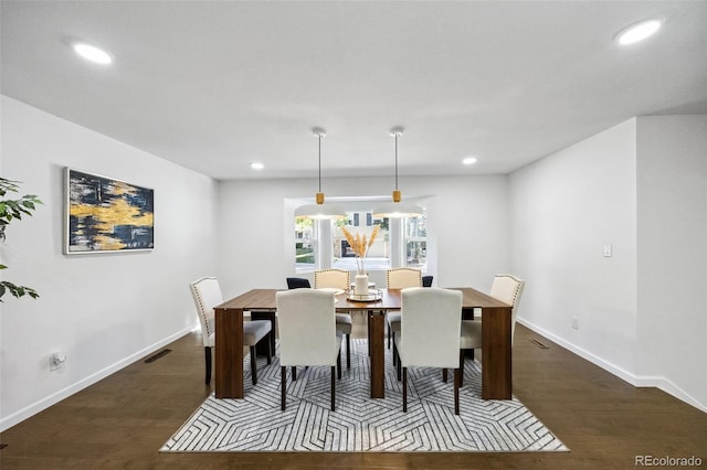 dining space with dark wood-type flooring