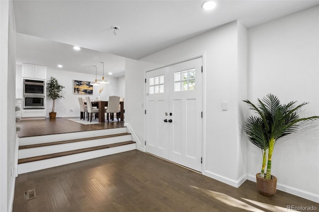 foyer entrance with dark hardwood / wood-style flooring