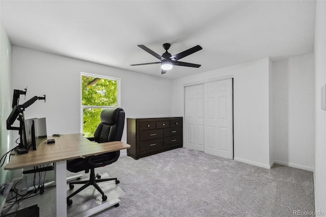 office with light carpet and ceiling fan