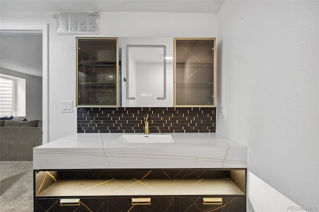 bathroom featuring vanity and decorative backsplash