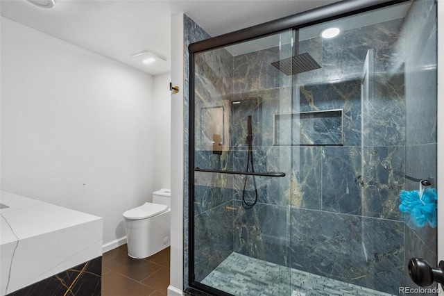 bathroom with tile patterned flooring, toilet, and walk in shower