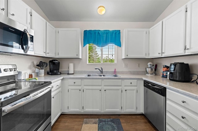 4421 Sunshine Cir, Loveland, CO 80538 - kitchen with stainless steel appliances, a sink, white cabinetry, dark wood finished floors, and light countertops