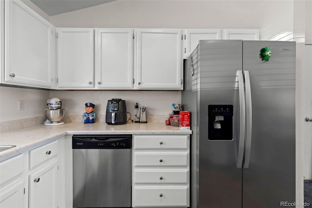 4421 Sunshine Cir, Loveland, CO 80538 - kitchen with appliances with stainless steel finishes, white cabinets, light countertops, and vaulted ceiling