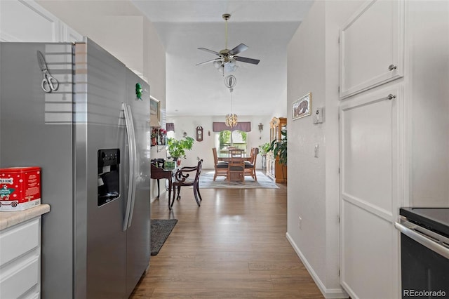 4421 Sunshine Cir, Loveland, CO 80538 - kitchen featuring stainless steel appliances, a ceiling fan, white cabinets, wood finished floors, and light countertops