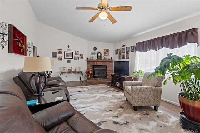 4421 Sunshine Cir, Loveland, CO 80538 - living area with a ceiling fan, lofted ceiling, wood finished floors, and a brick fireplace