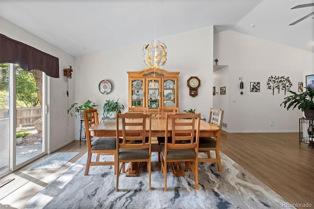4421 Sunshine Cir, Loveland, CO 80538 - dining space featuring light wood finished floors, vaulted ceiling, ceiling fan, and a chandelier