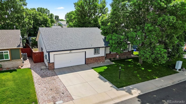 4421 Sunshine Cir, Loveland, CO 80538 - view of front facade featuring roof with shingles, concrete driveway, brick siding, and central air condition unit