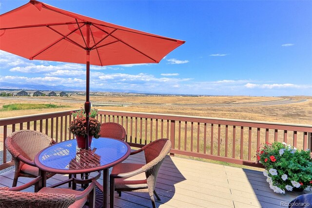 wooden deck with a rural view