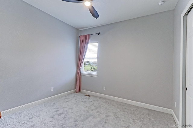 carpeted spare room featuring ceiling fan