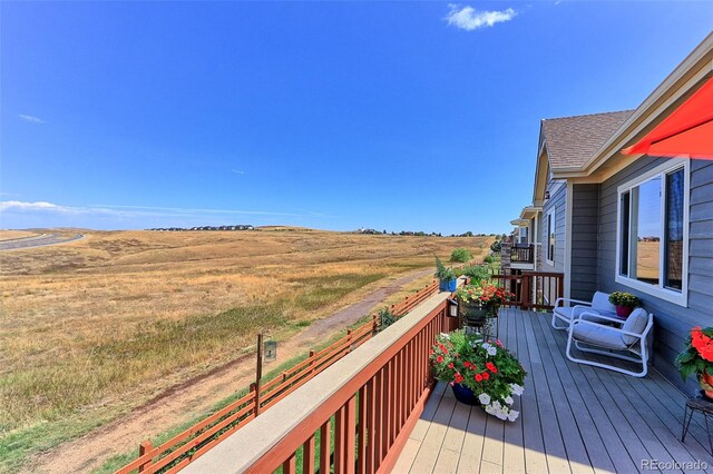 wooden terrace with a rural view