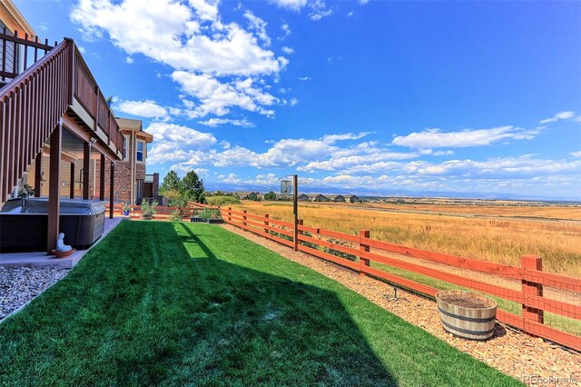 view of yard with a hot tub and a rural view