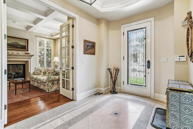 entrance foyer featuring crown molding, coffered ceiling, tile patterned floors, and beam ceiling