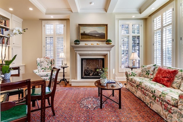 living area featuring wood-type flooring and ornamental molding