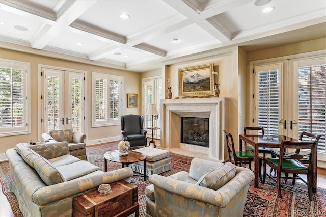 living room with plenty of natural light, a fireplace, beam ceiling, and french doors