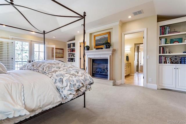 carpeted bedroom featuring access to outside, ensuite bath, and french doors