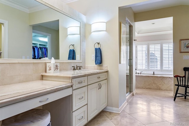 bathroom featuring tile patterned flooring, crown molding, vanity, and plus walk in shower