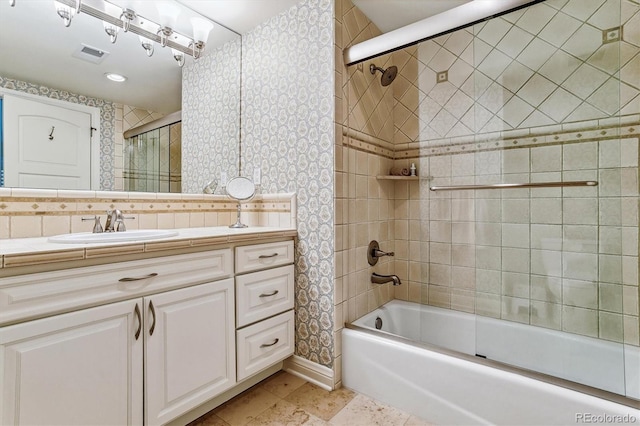 bathroom with vanity and bath / shower combo with glass door