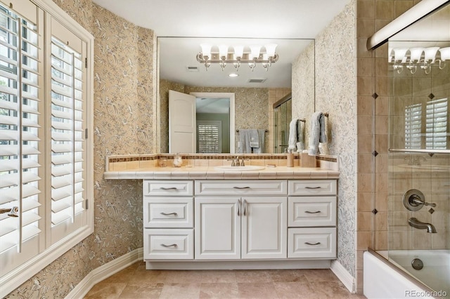 bathroom with bath / shower combo with glass door, vanity, and tile patterned floors