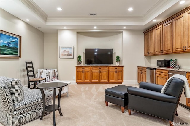 living room with a raised ceiling, crown molding, light carpet, and built in desk