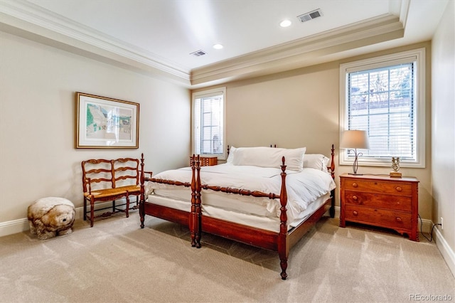 carpeted bedroom with ornamental molding and a raised ceiling