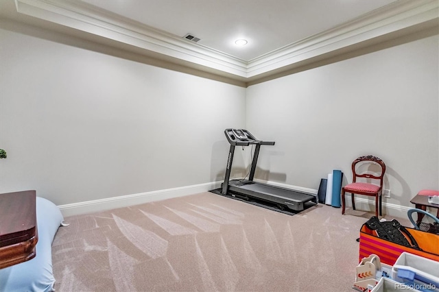 exercise room featuring ornamental molding and carpet floors