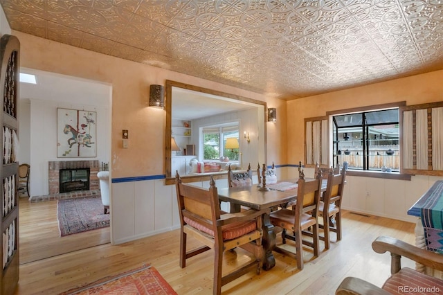 2309 E Floyd Pl, Englewood, CO 80113 - dining area with an ornate ceiling, light wood-style floors, and a brick fireplace
