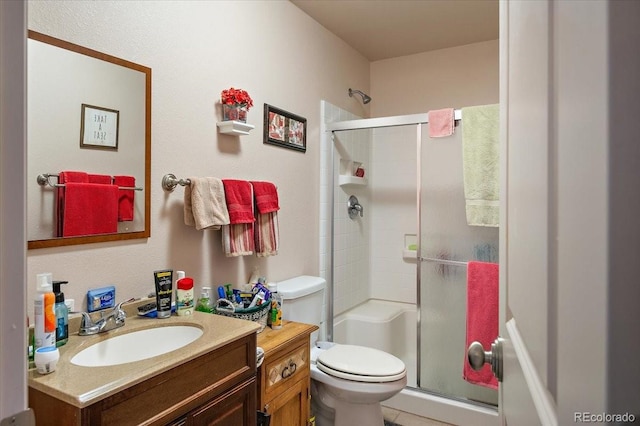 1176 E Purcell Ln, Pueblo, CO 81007 - bathroom with a shower stall, vanity, toilet, and tile patterned flooring