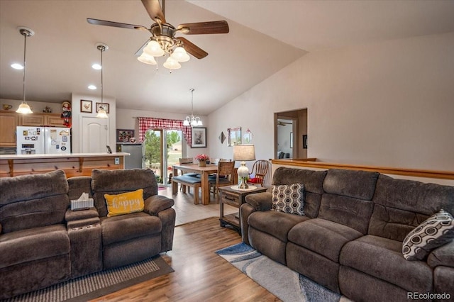 1176 E Purcell Ln, Pueblo, CO 81007 - living room featuring vaulted ceiling, a ceiling fan, light wood finished floors, a chandelier, and recessed lighting