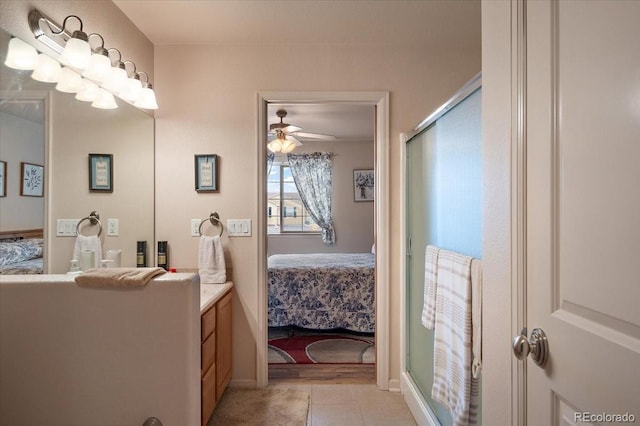 1176 E Purcell Ln, Pueblo, CO 81007 - ensuite bathroom with vanity, a stall shower, ceiling fan, and tile patterned flooring