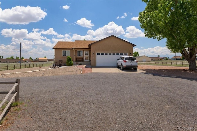 1176 E Purcell Ln, Pueblo, CO 81007 - ranch-style home featuring driveway, a garage, and stucco siding