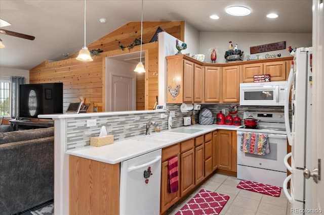 1176 E Purcell Ln, Pueblo, CO 81007 - kitchen with white appliances, vaulted ceiling, open floor plan, wood walls, and a ceiling fan