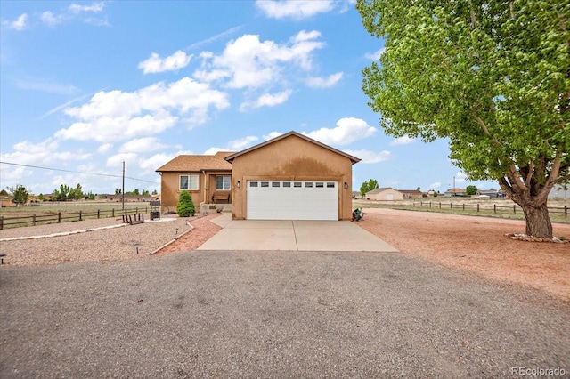 1176 E Purcell Ln, Pueblo, CO 81007 - ranch-style home with concrete driveway, a garage, and stucco siding