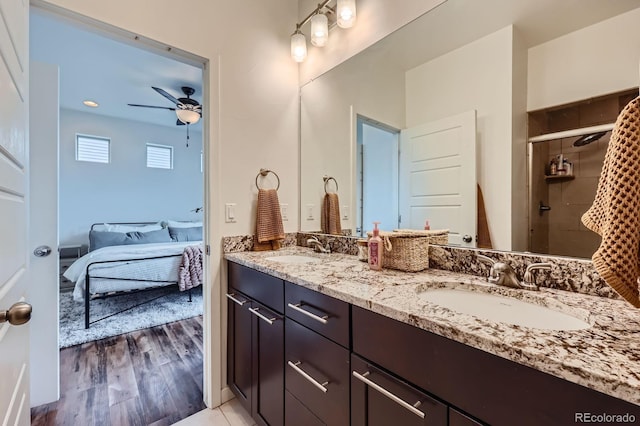 2592 Sweet Wind Ave, Castle Rock, CO 80109 - full bath featuring a ceiling fan, double vanity, ensuite bathroom, a shower stall, and wood finished floors