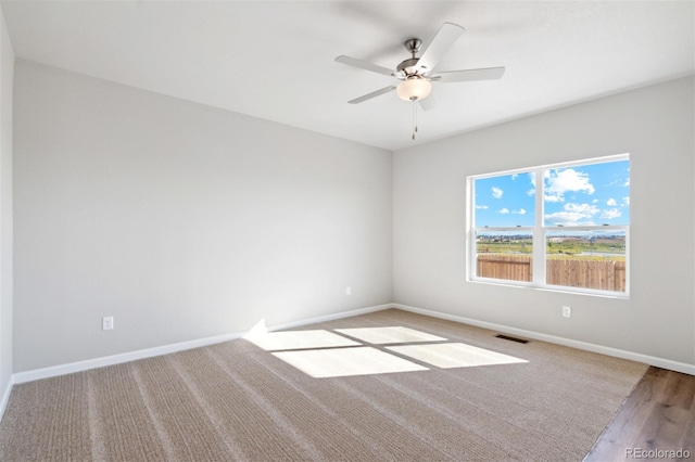 empty room featuring ceiling fan and light hardwood / wood-style floors