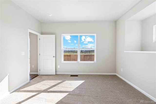 unfurnished room with light carpet