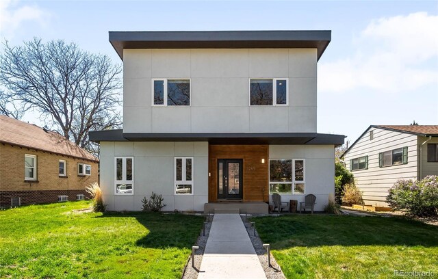 view of front facade with a front lawn, stucco siding, and cooling unit