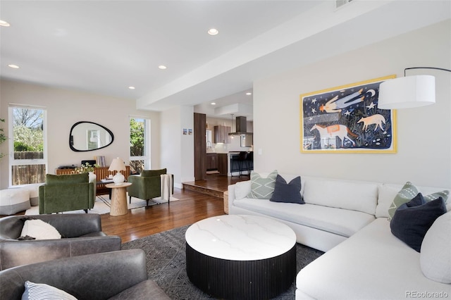 living room with wood finished floors, plenty of natural light, and recessed lighting