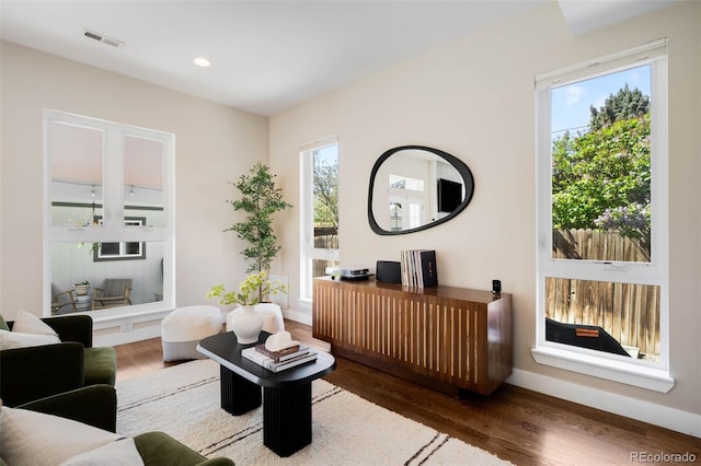 living area with wood finished floors, baseboards, and recessed lighting