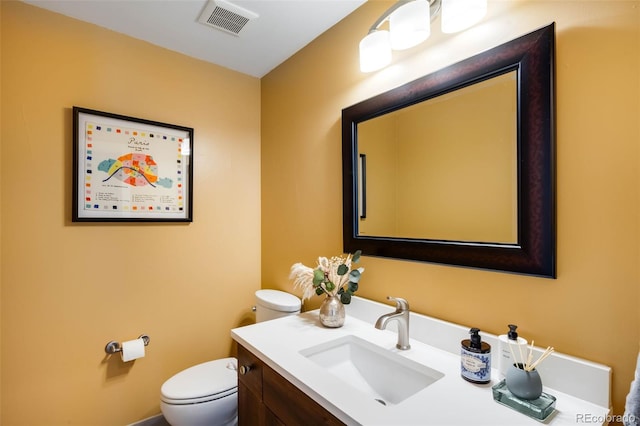 half bathroom with toilet and vanity