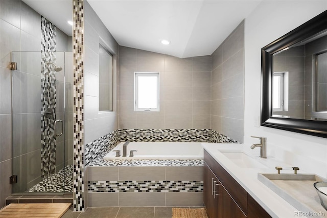 bathroom with a shower stall, a bath, double vanity, tile patterned floors, and recessed lighting