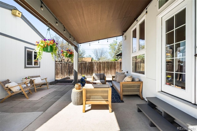 view of patio / terrace featuring an outdoor living space and fence