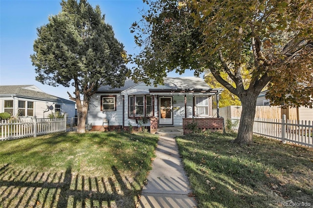 bungalow featuring a front lawn and a pergola