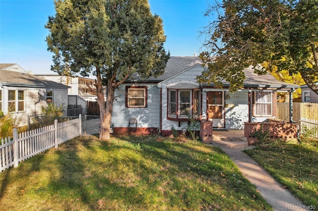 1340 Xanthia St, Denver, CO 80220 - bungalow with a fenced backyard, a front yard, and a shingled roof