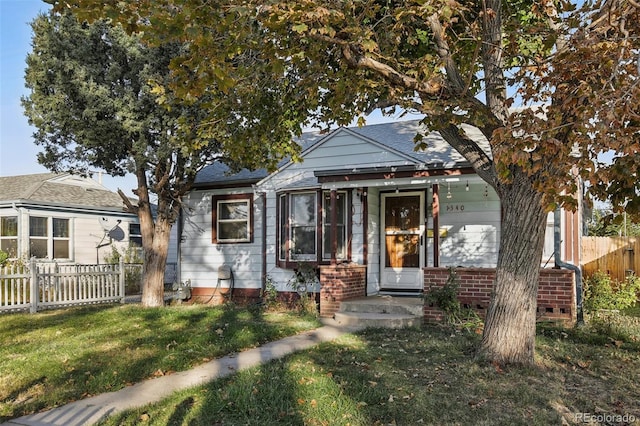 bungalow-style home with a front lawn