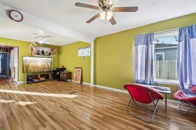 sitting room featuring light hardwood / wood-style flooring and ceiling fan