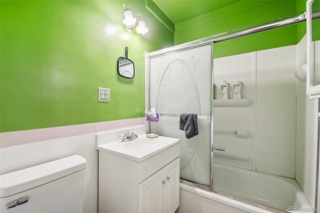 full bathroom with vanity, enclosed tub / shower combo, and toilet