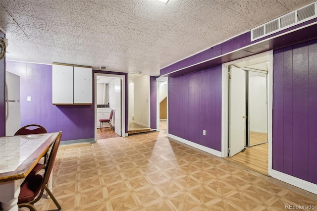 1340 Xanthia St, Denver, CO 80220 - kitchen with baseboards, white cabinets, and visible vents