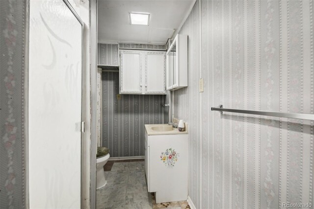 1340 Xanthia St, Denver, CO 80220 - bathroom with vanity, baseboards, and toilet